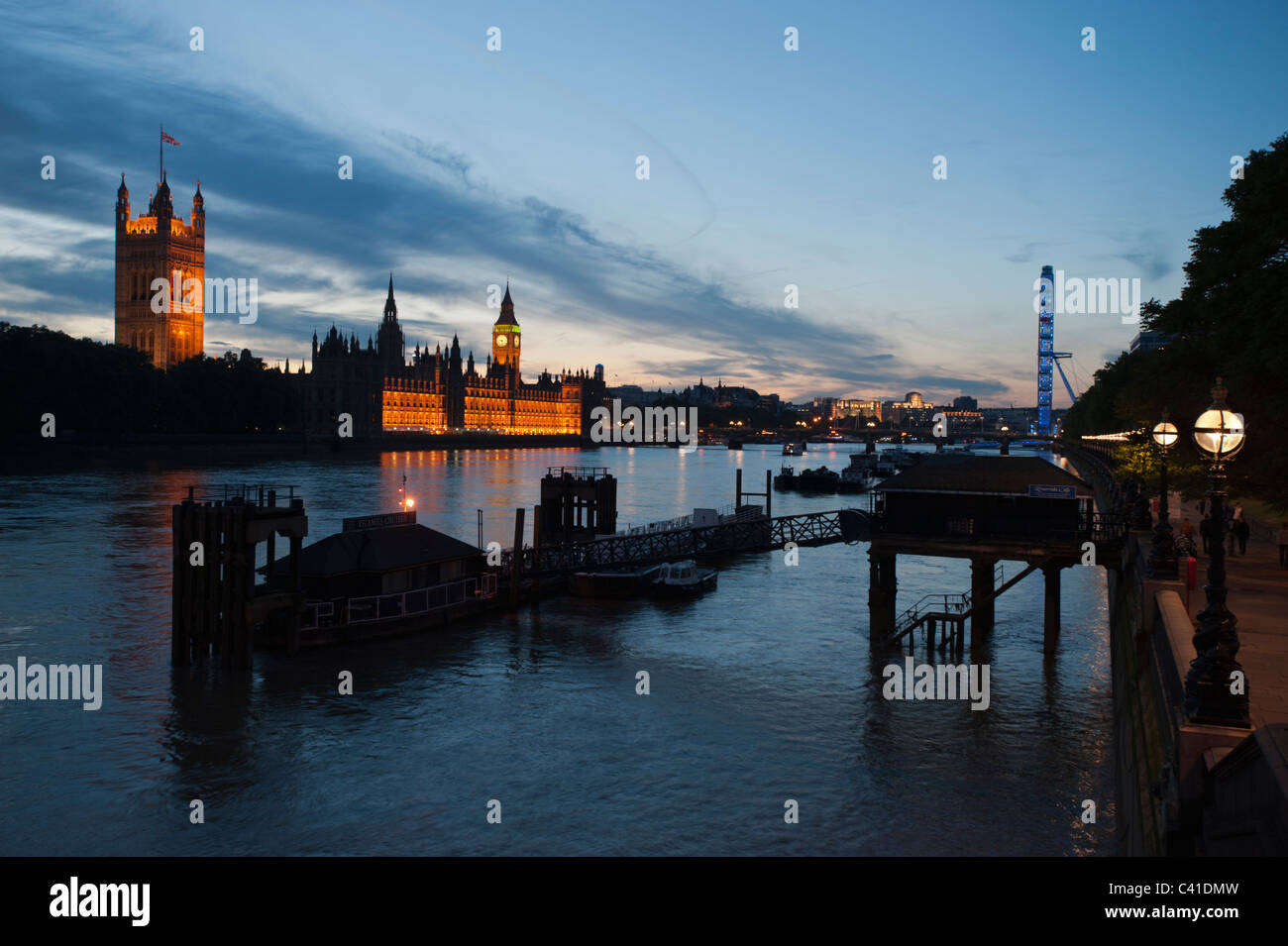 The River Thames in central London at dusk, showing the Houses of Parliament and the London Eye