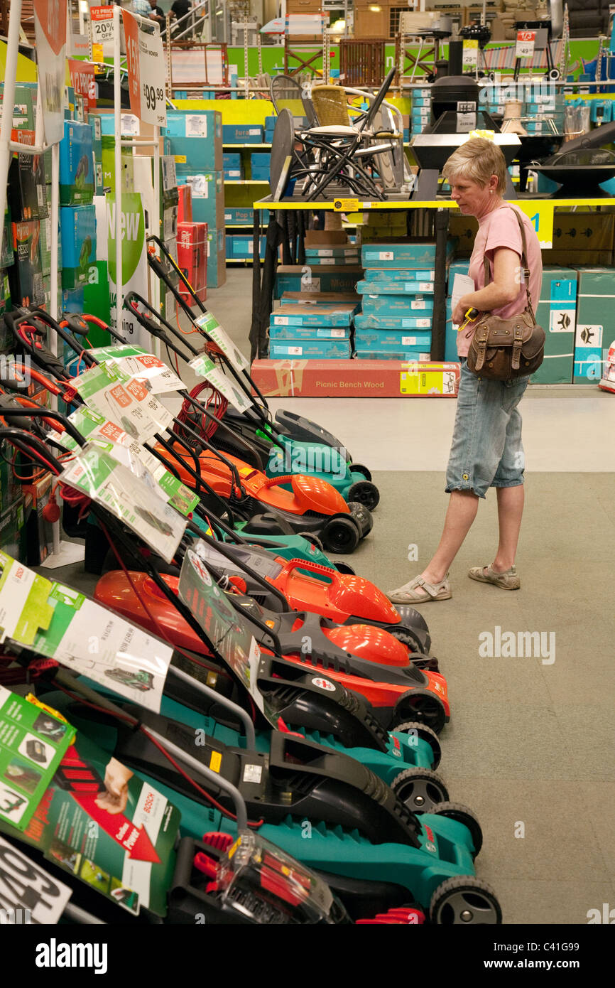 Shoppers looking at lawnmowers and gardening equipment, Homebase store, Newmarket Suffolk UK Stock Photo