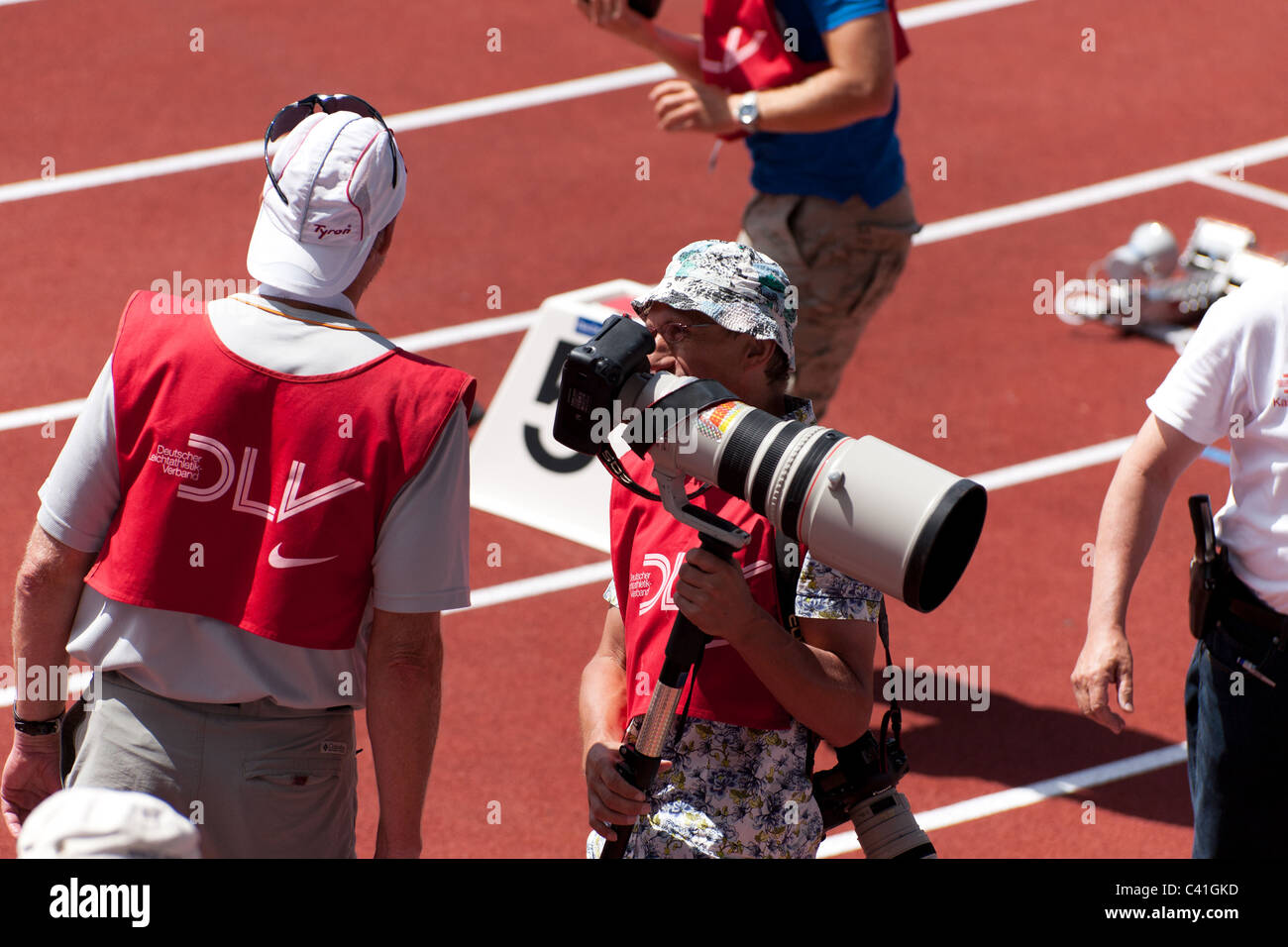 High resolution image of a photographer at a sport event with a huge