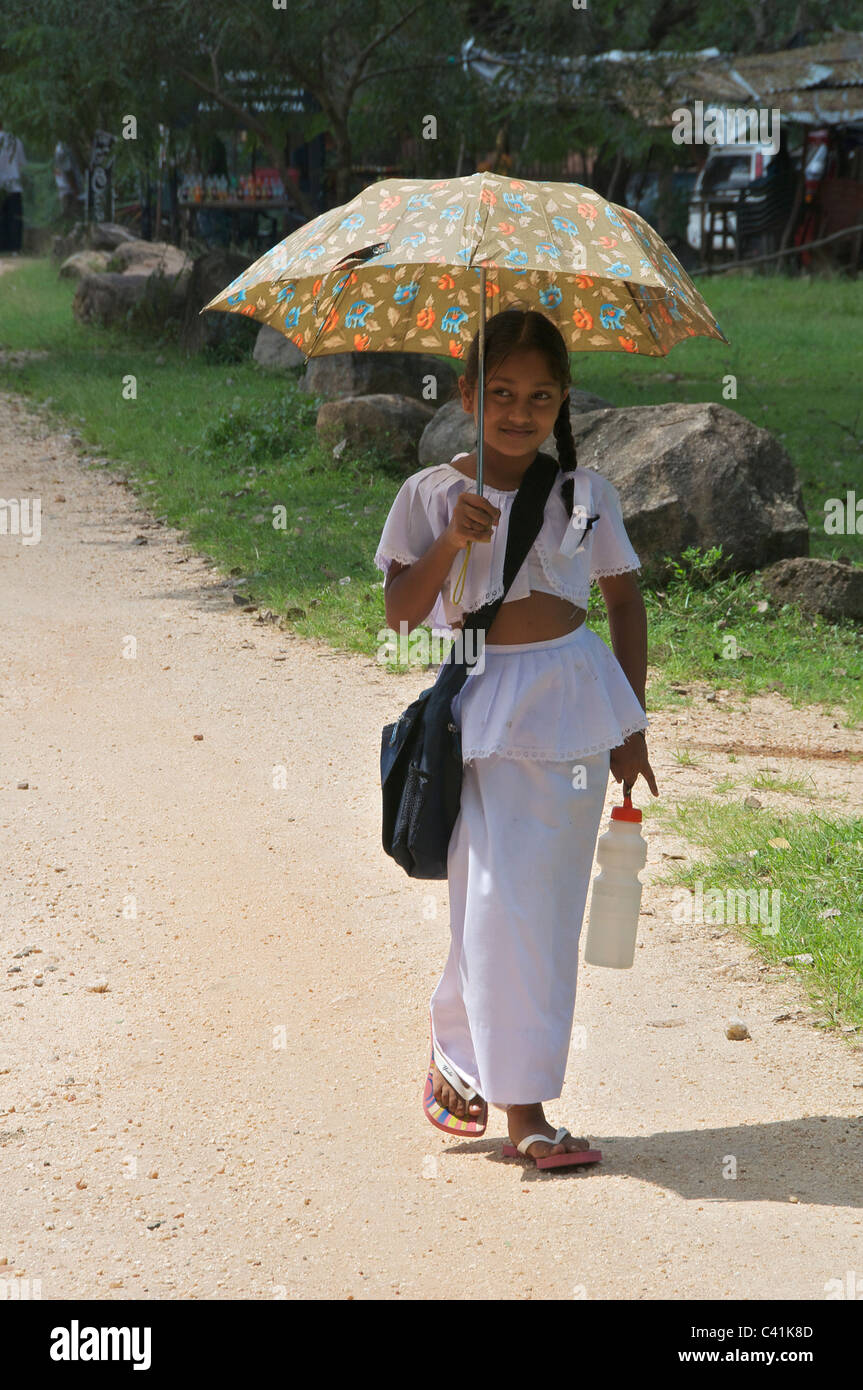 Pretty young girl with parasol Polonnaruwa Sri Lanka Stock Photo