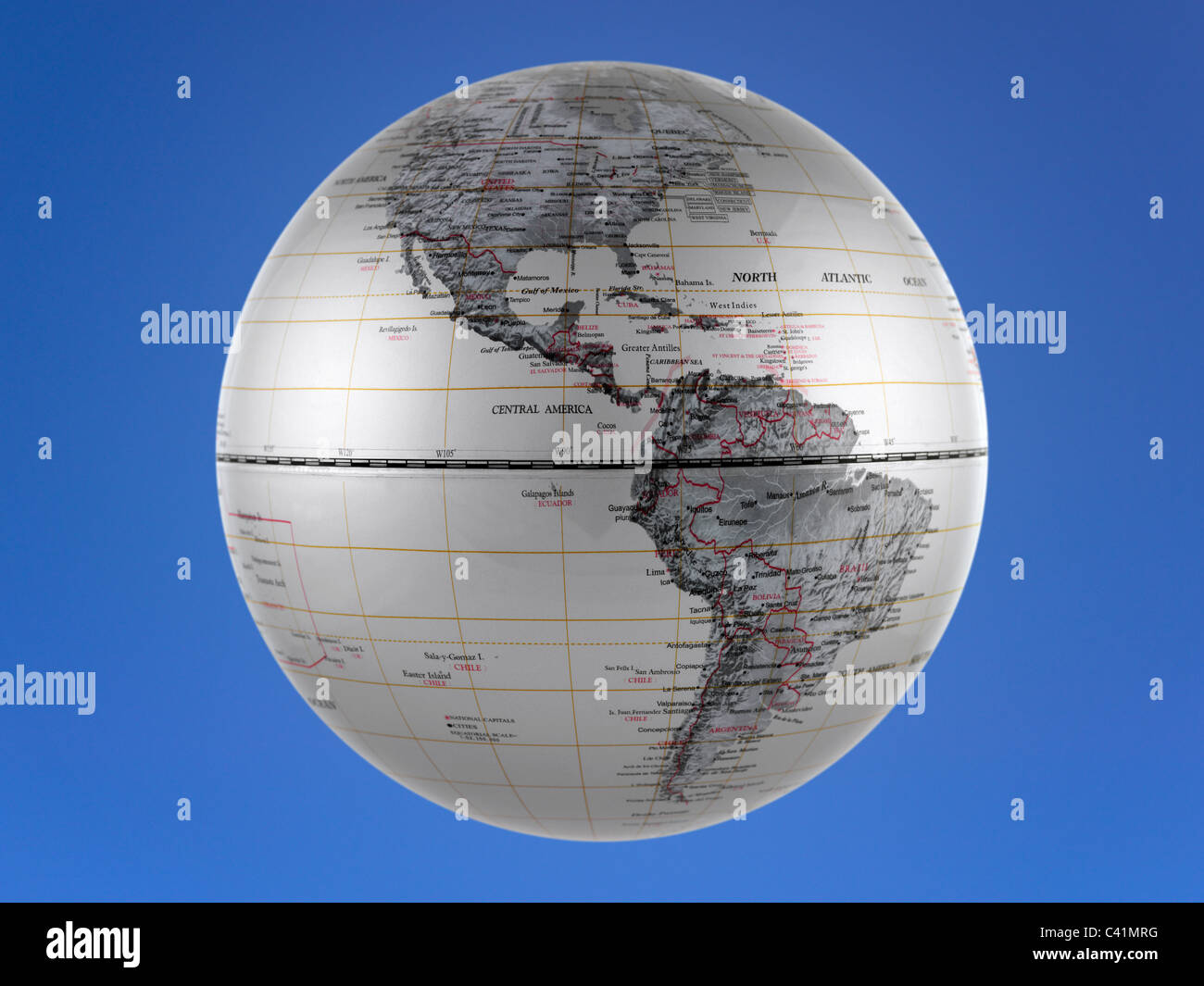 A world globe isolated aqainst a blue background Stock Photo - Alamy