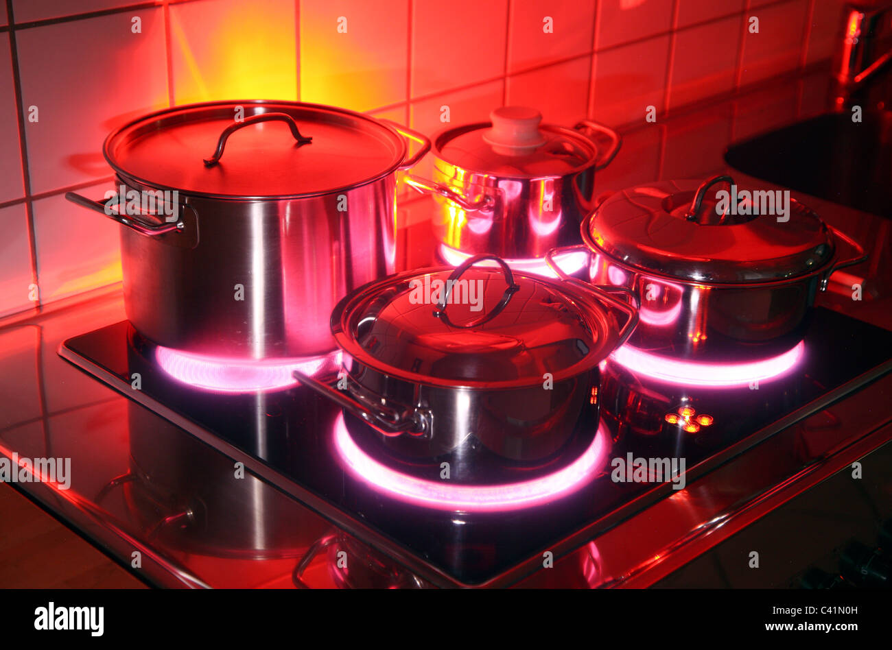 home kitchen, cooking pots, made of stainless steel, on a hot glass