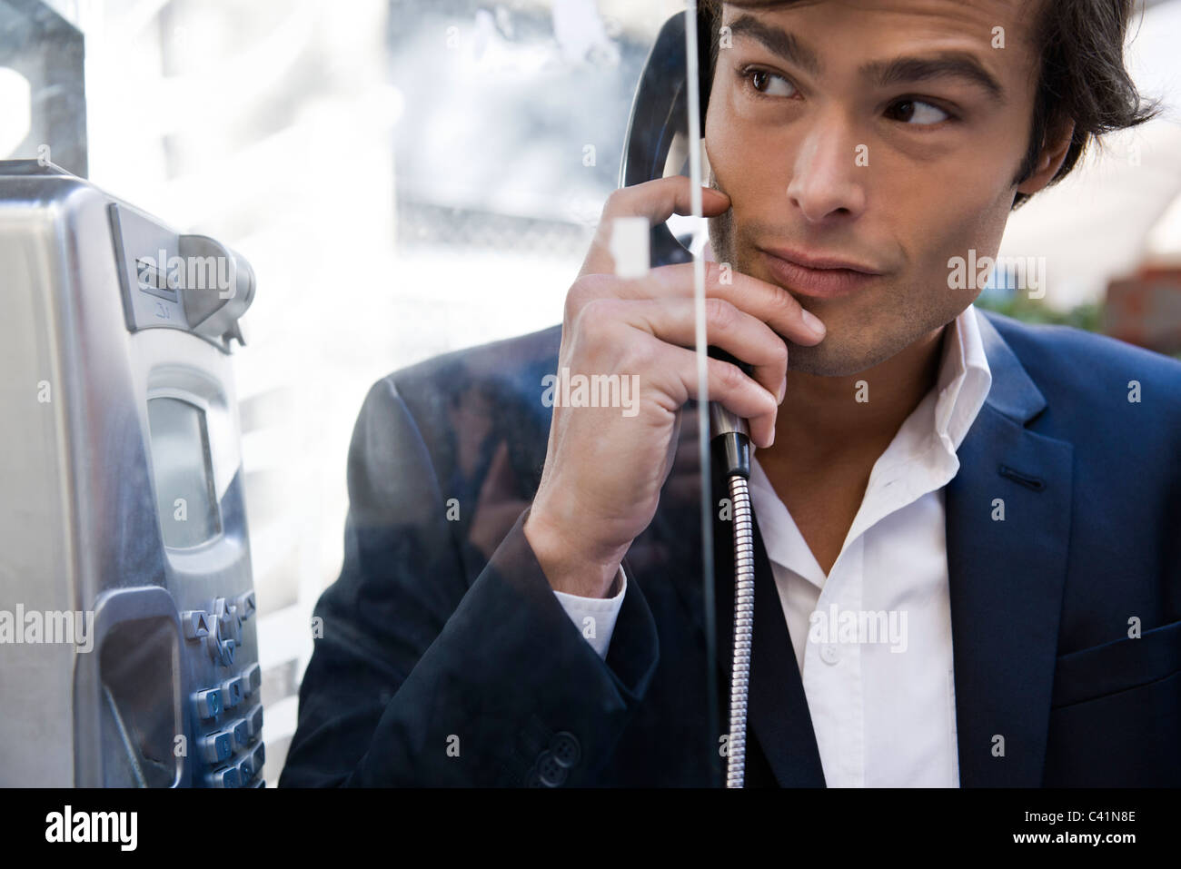 Man using pay phone Stock Photo