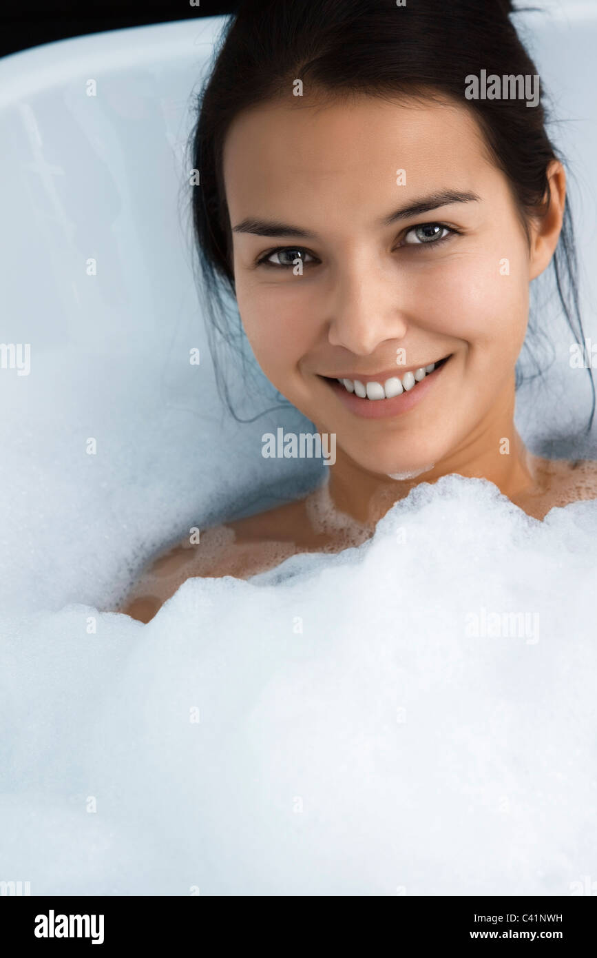 Woman taking a bubble bath in a bathtub hi-res stock photography and