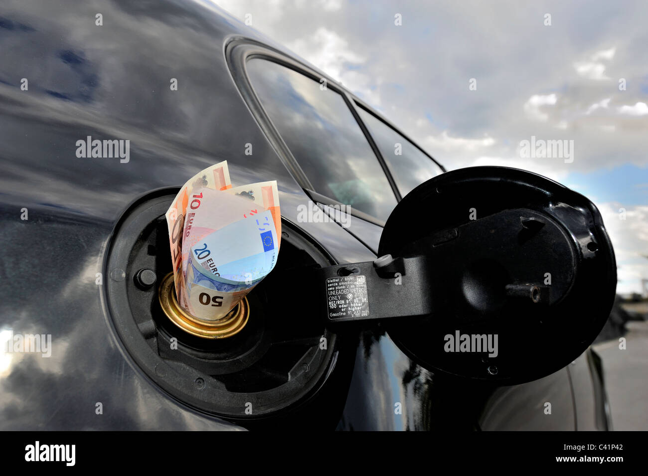 Banknotes in the Fuel Tank of a Car Stock Photo