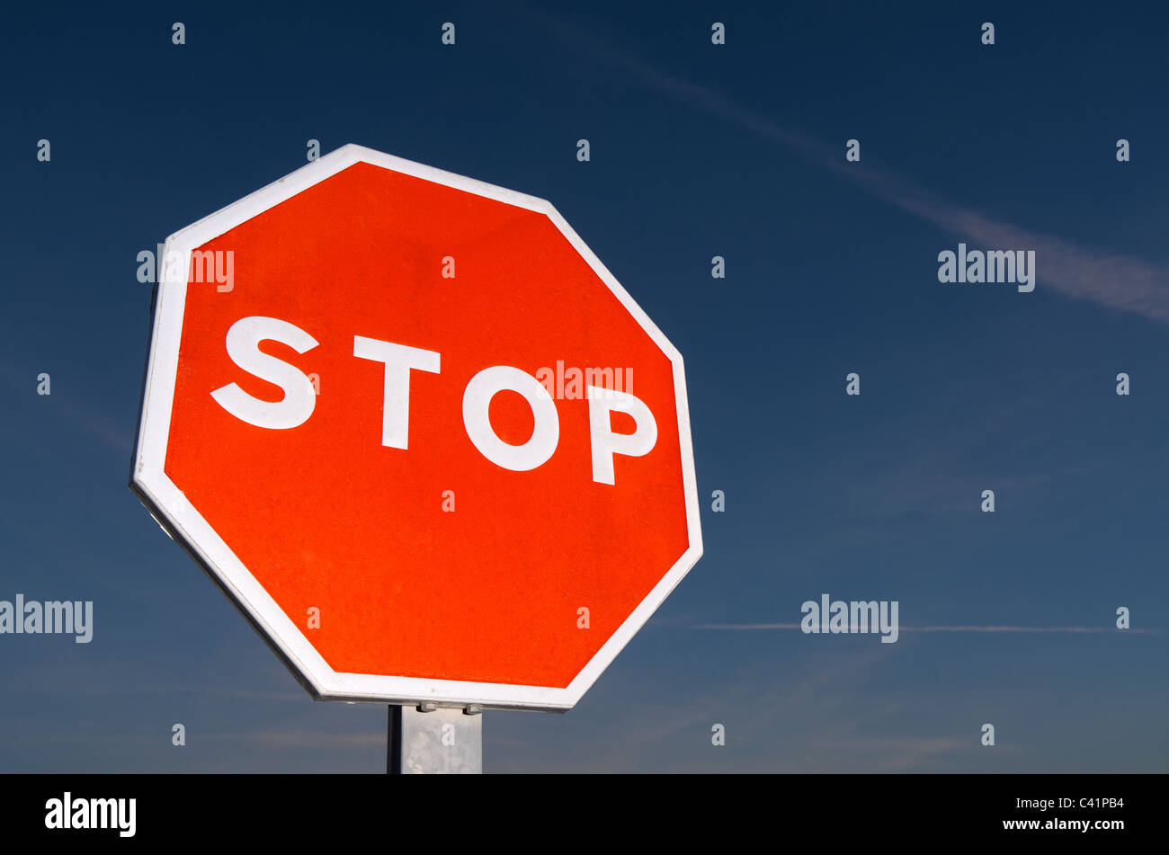 forefront of a stop sign with a blue sky at sunset Stock Photo - Alamy