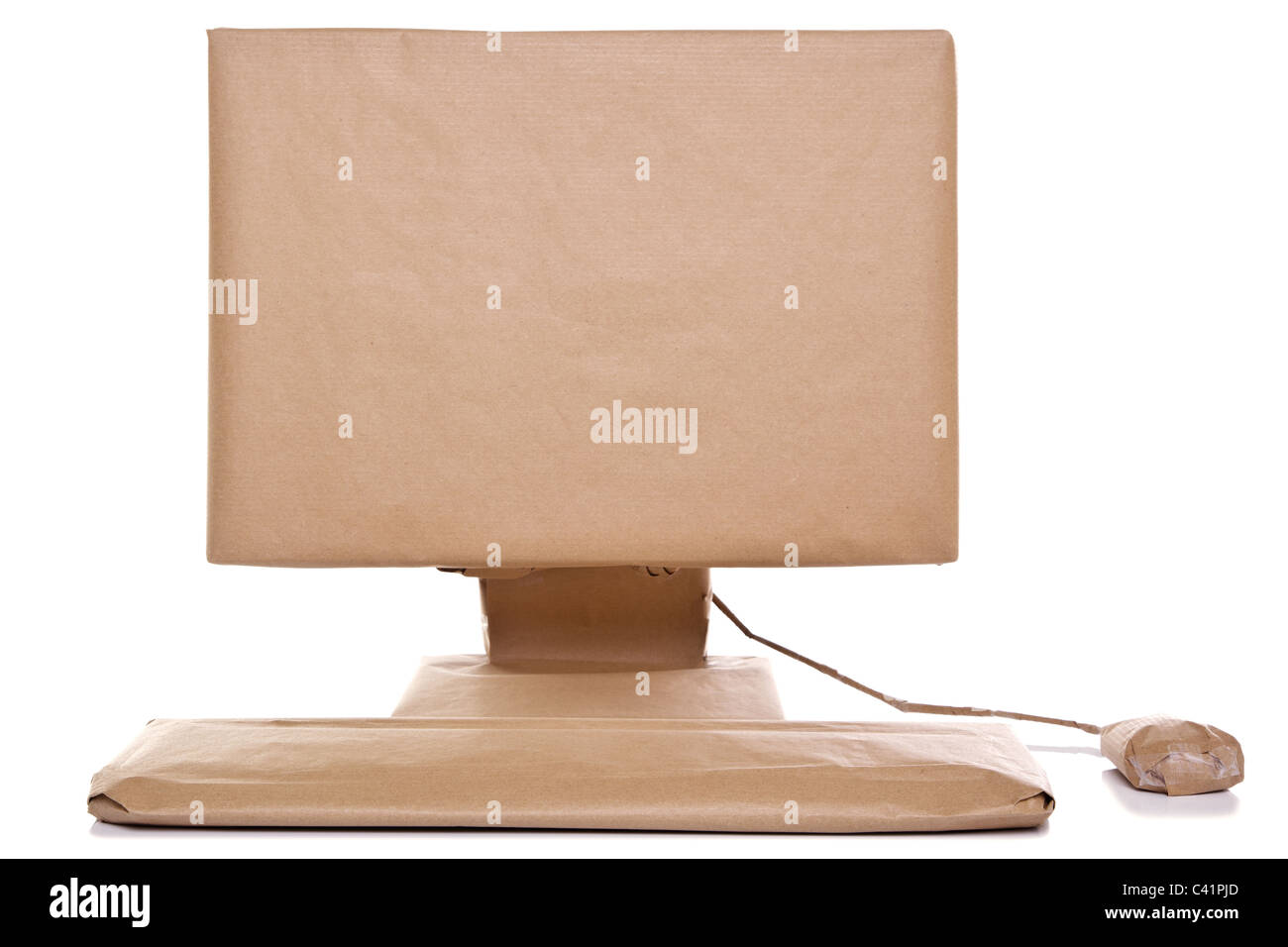 Photo of a computer wrapped in recycled brown paper, isolated on a white background. Stock Photo