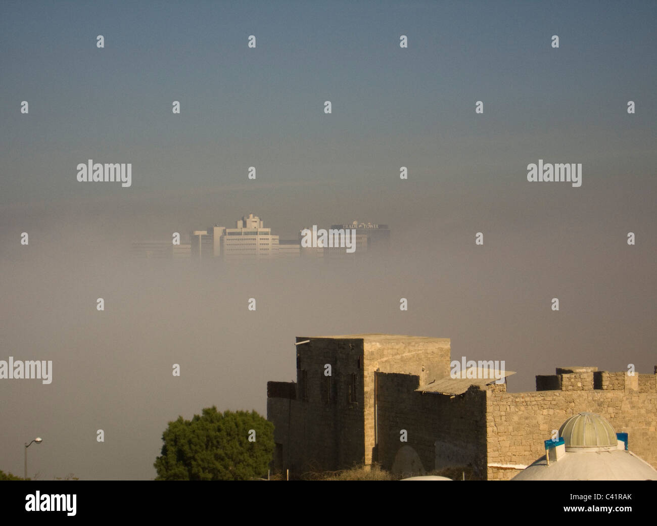 Atmospheric view from old Jaffa  through mist to modern skyscrapers of Tel Aviv Stock Photo