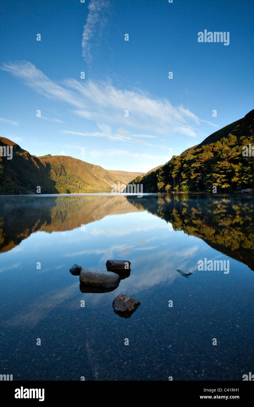 Morning reflections in Upper Lake, Glendalough, Wicklow Mountains National Park, County Wicklow, Ireland. Stock Photo
