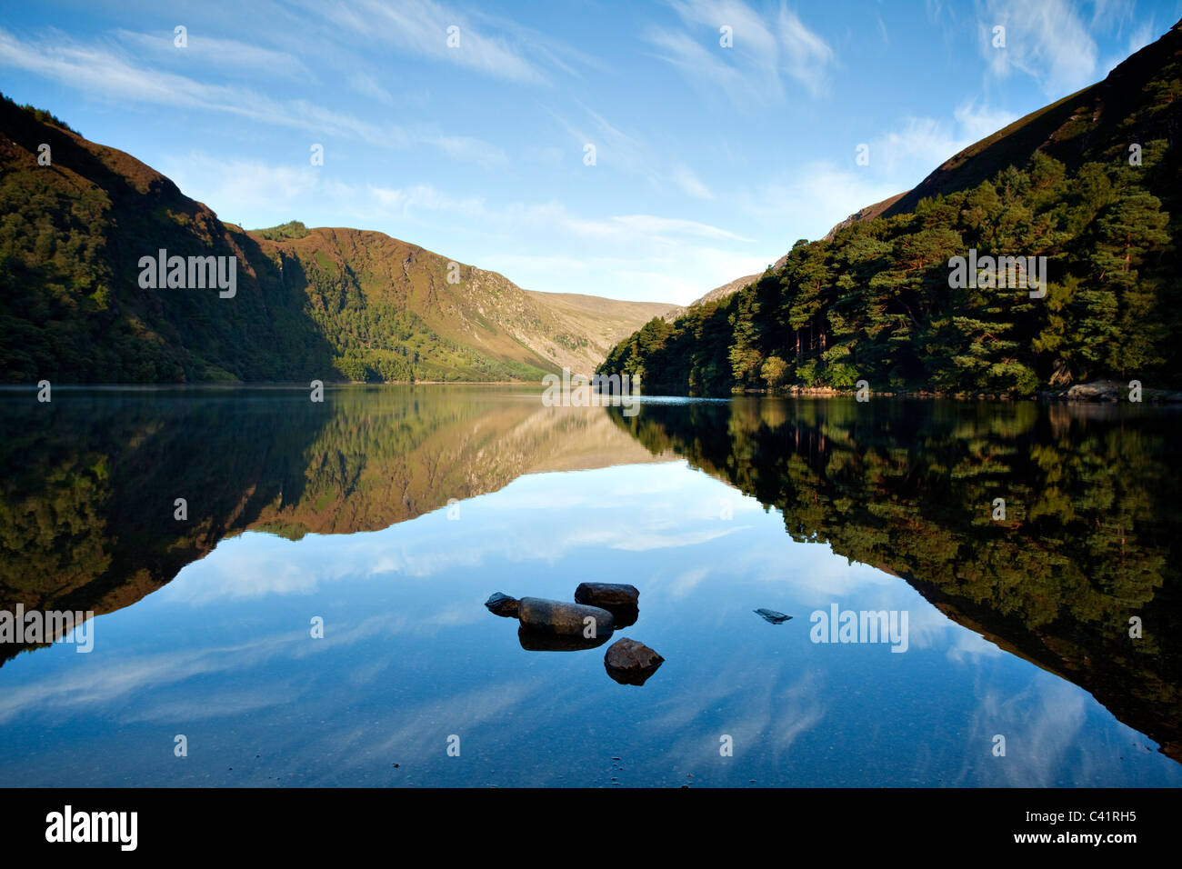 Morning reflections in Upper Lake, Glendalough, Wicklow Mountains National Park, County Wicklow, Ireland. Stock Photo