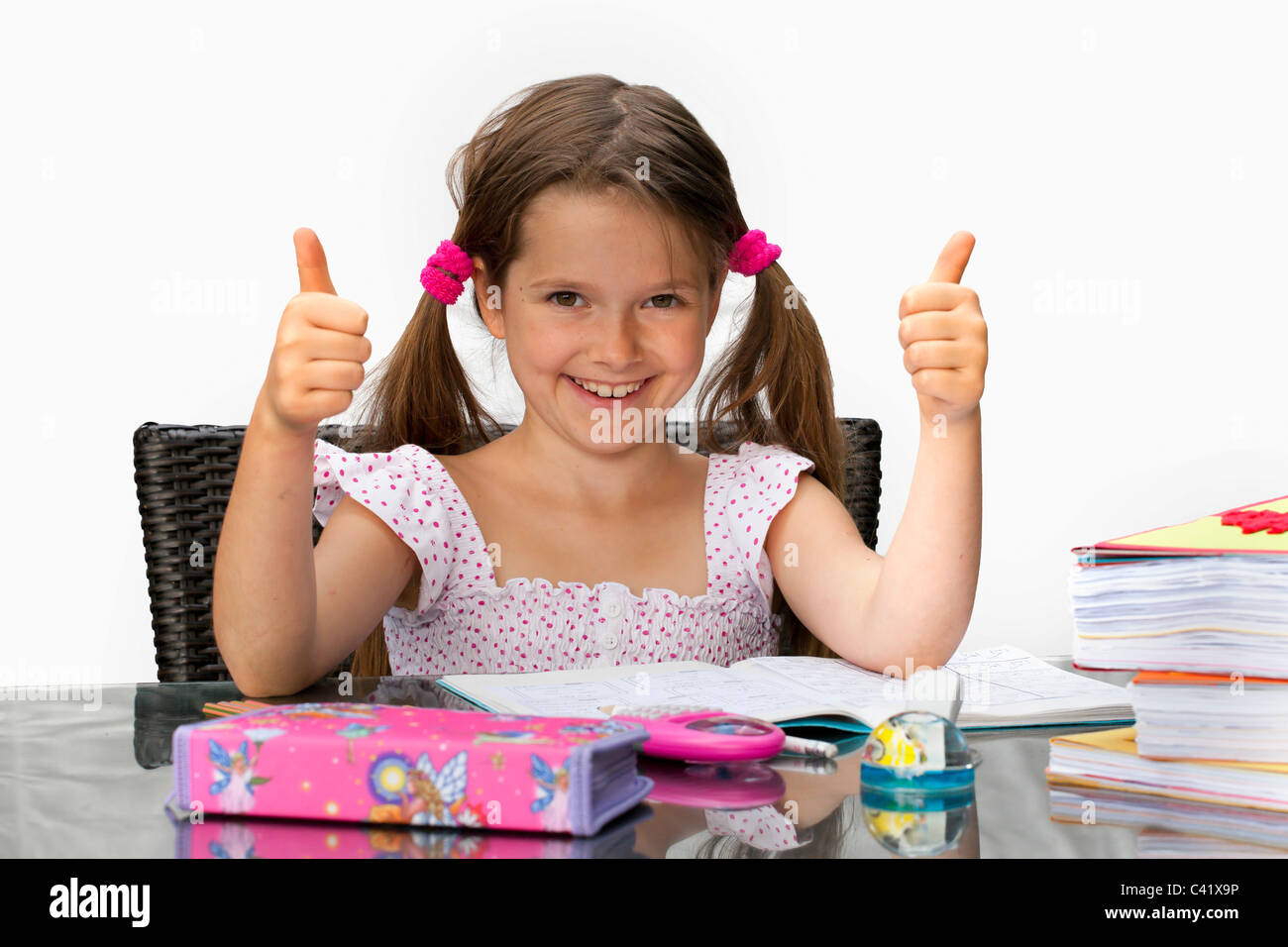 7 year old girl at the table with homework Stock Photo - Alamy