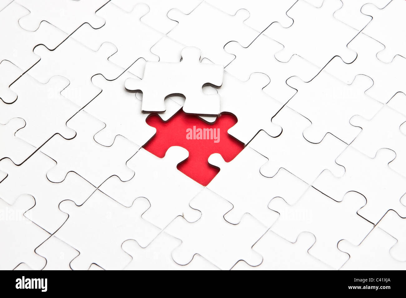 a puzzle with missing parts, which are connected Stock Photo