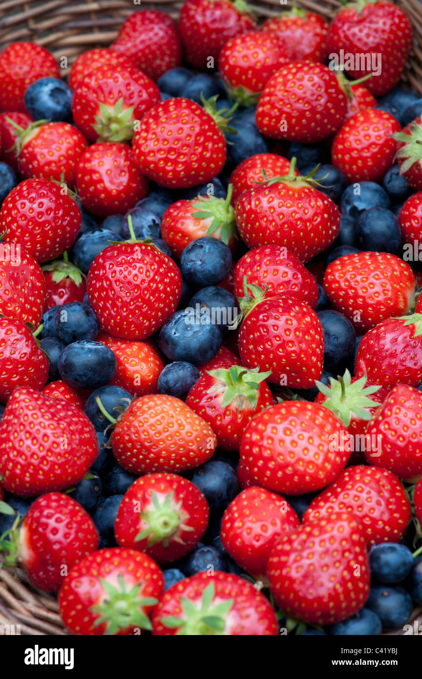 Strawberries and blueberries in a wicker basket Stock Photo