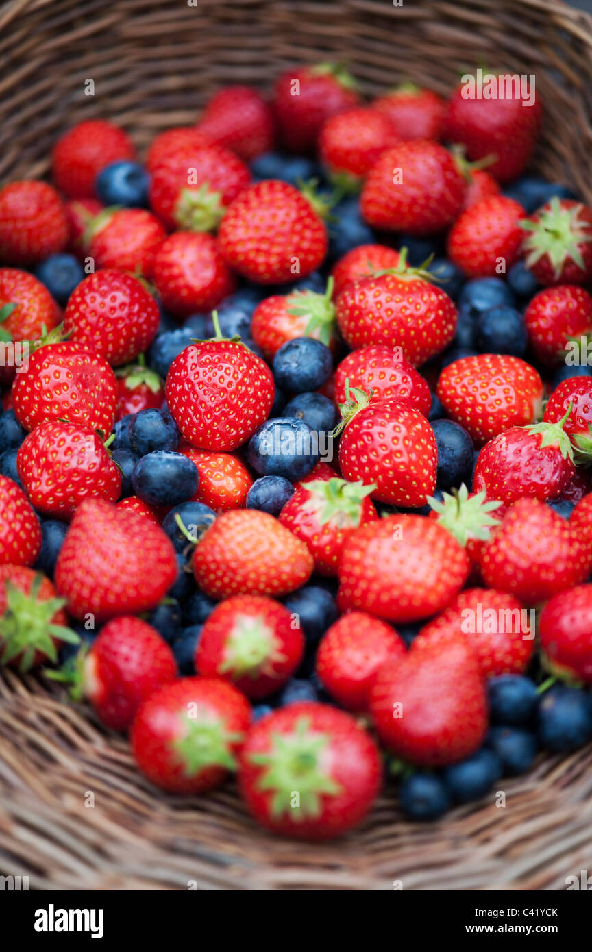 Strawberries and blueberries in a wicker basket Stock Photo