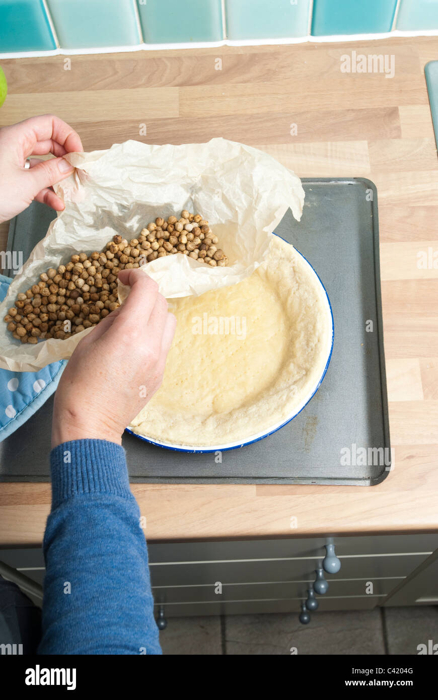 Blind baking beans being lifted from a pastry case UK Stock Photo Alamy