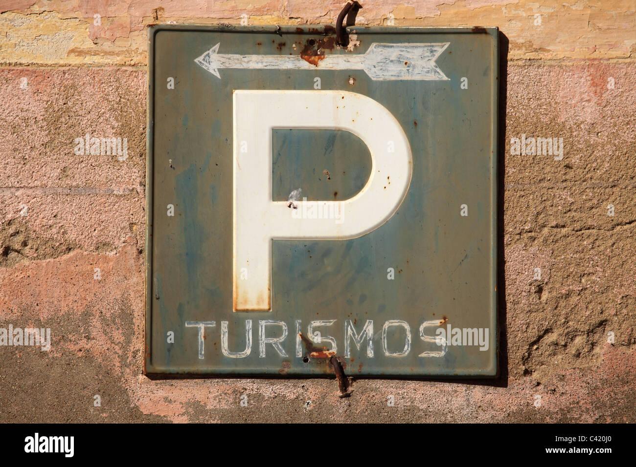 A 'P' denotes parking for tourists (Turismos) on a street in Alcantara in Spain. Stock Photo