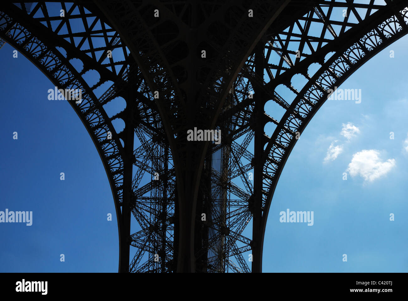 Small clouds under the arch of the Eiffel Tower Stock Photo