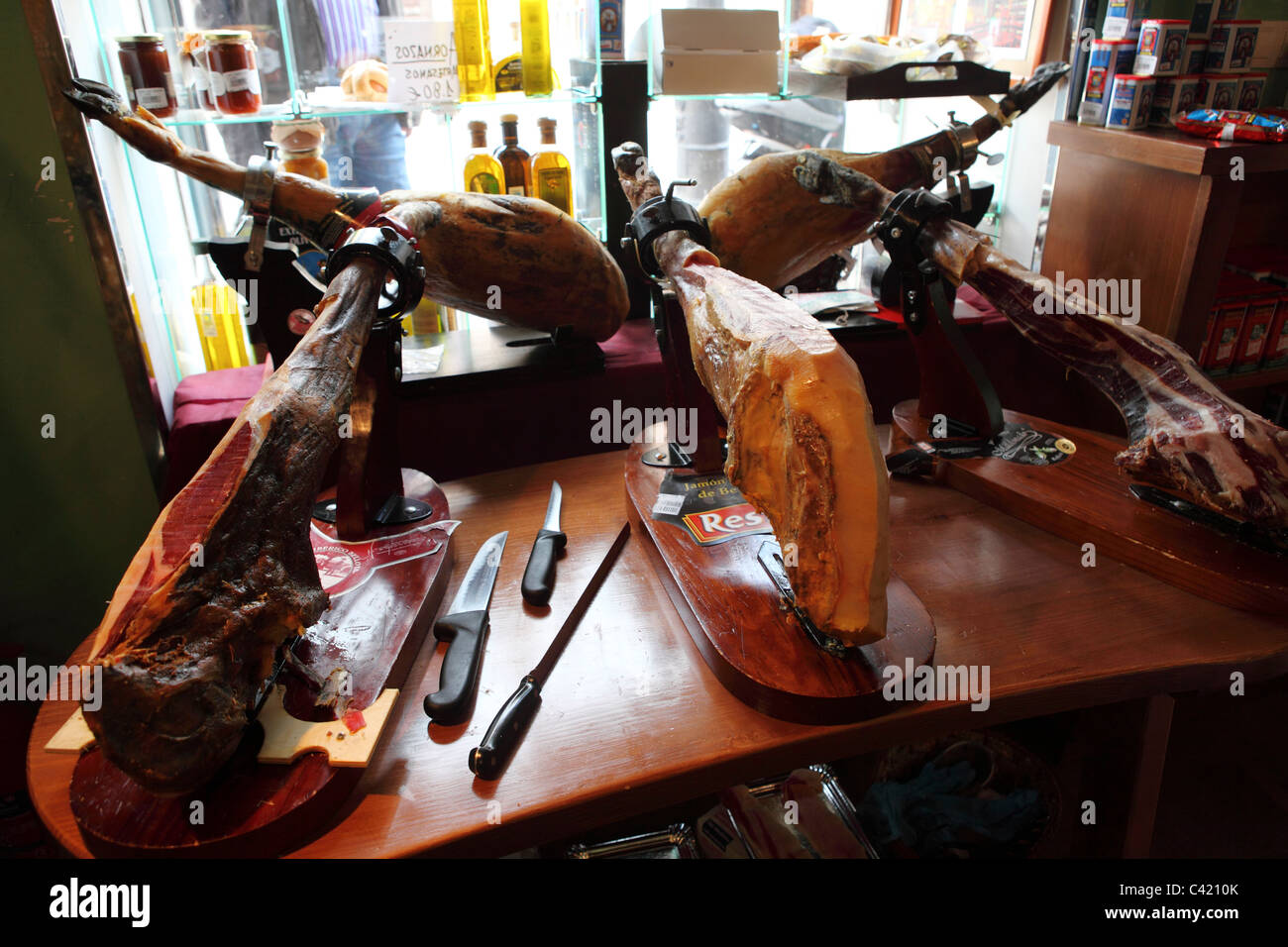 Iberian hams ready for cutting in delicatessen in Merida, in the Extremadura district of Spain. Stock Photo