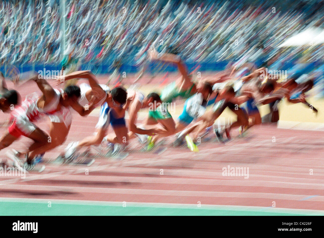 Blurred action at the start of a mens 100 meter track and field race. Stock Photo