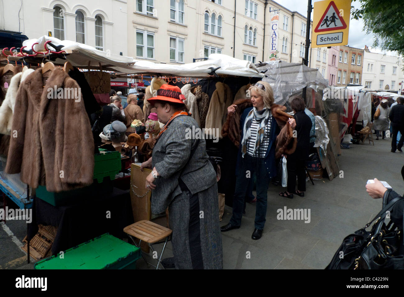Fur coats and jackets for sale on a Portobello Road market stall Notting Hill London England UK Stock Photo