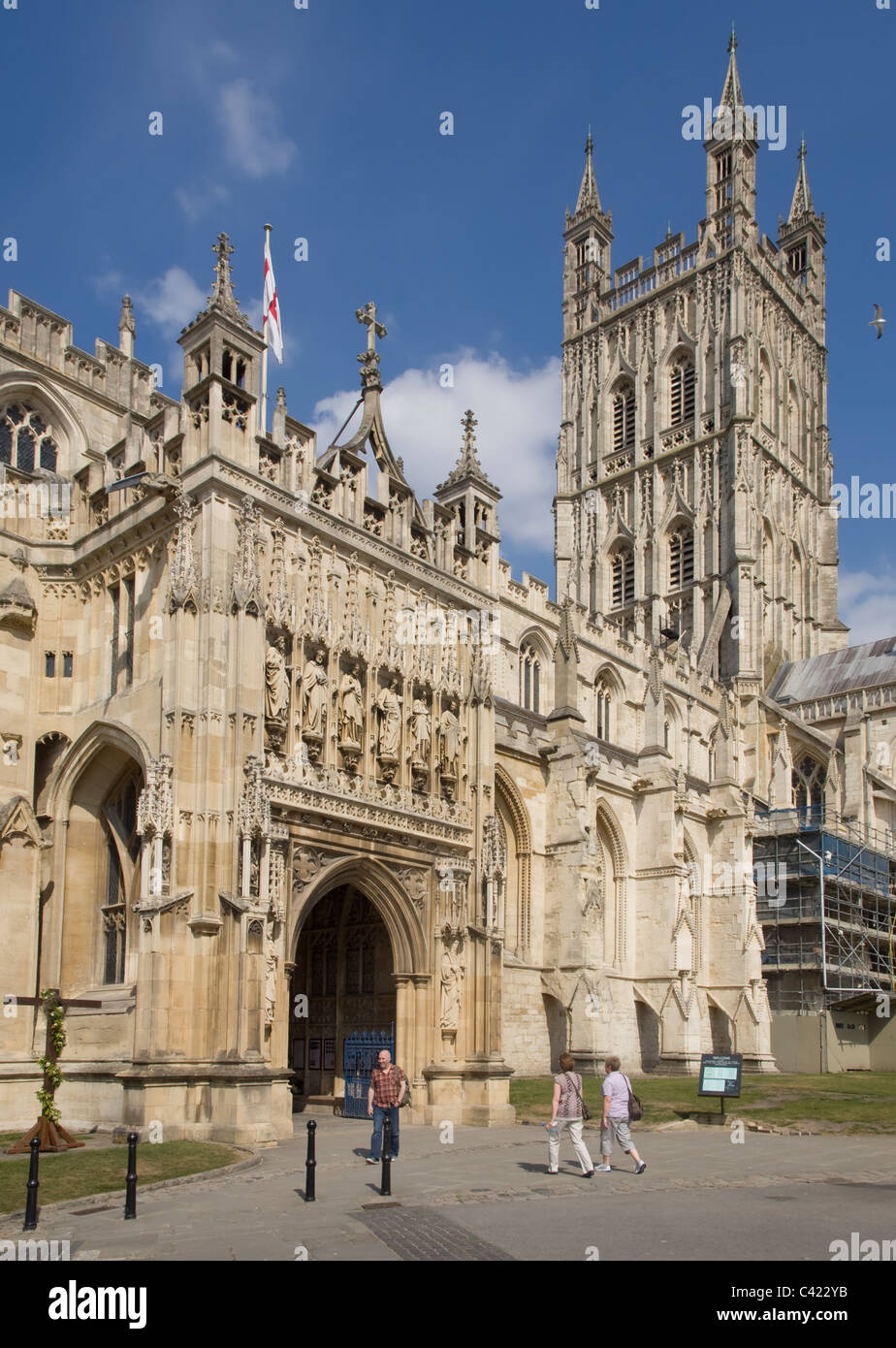 Gloucester cathedral main entrance with some restoration work on the wall nearby. Stock Photo