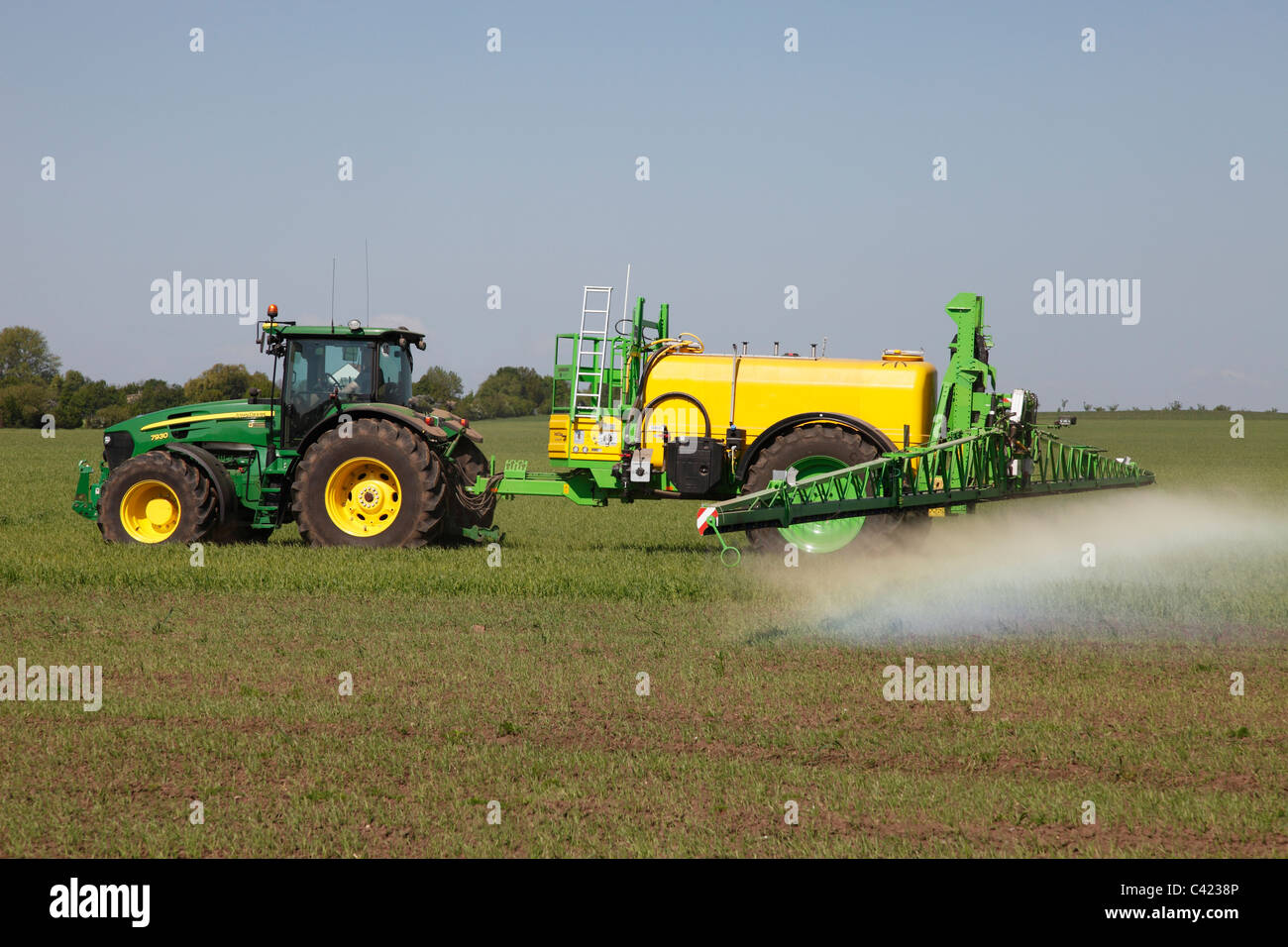 spraying herbicide in a grain field Stock Photo