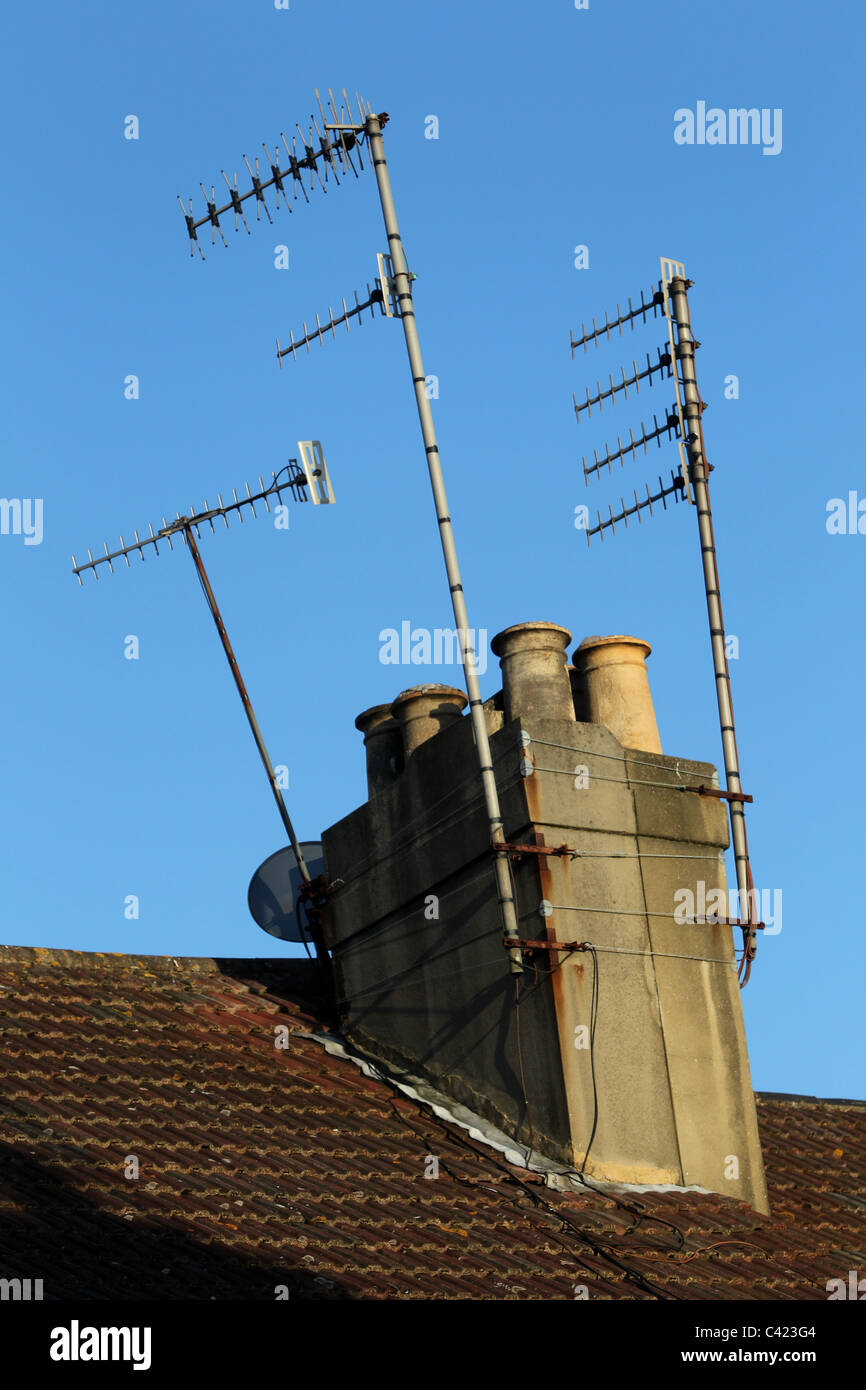 Roof chimney lit by the setting sun on a terraced home in Hove, East Sussex, UK. Stock Photo