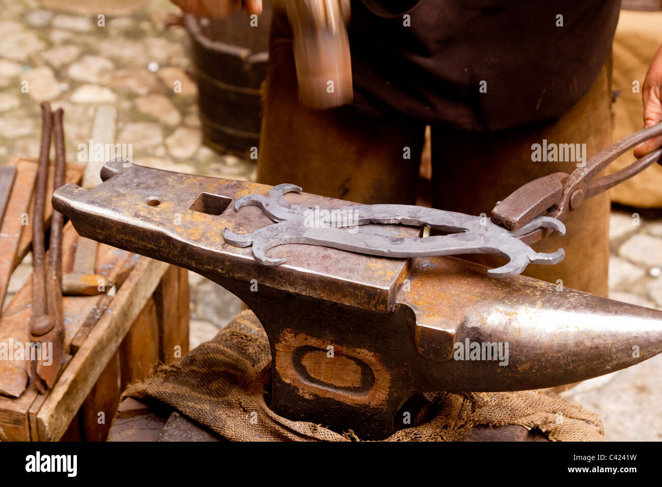 blacksmith forged iron smith anvil hammerman traditional hammer beating Stock Photo