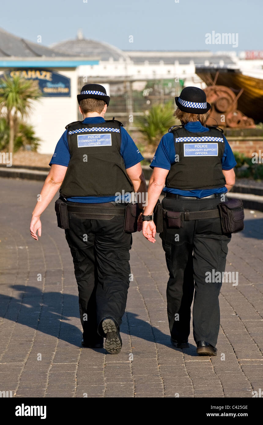 Two female Police Community Support Officers patrolling Brighton seafront. Stock Photo