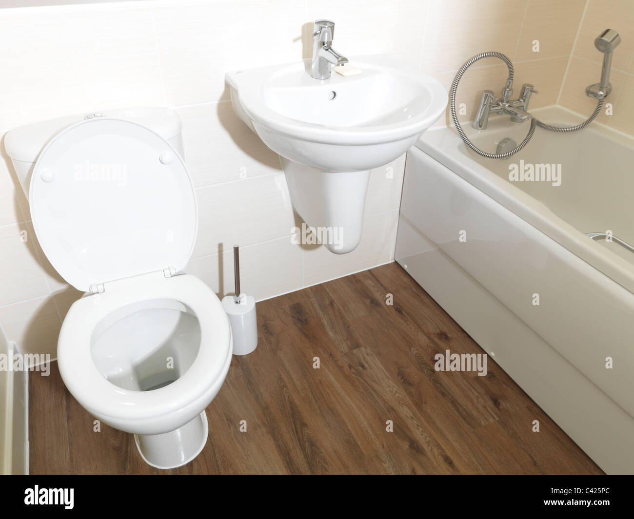 New Apartment Bathroom Toilet, Basin And Bath With Shower Attached Stock Photo
