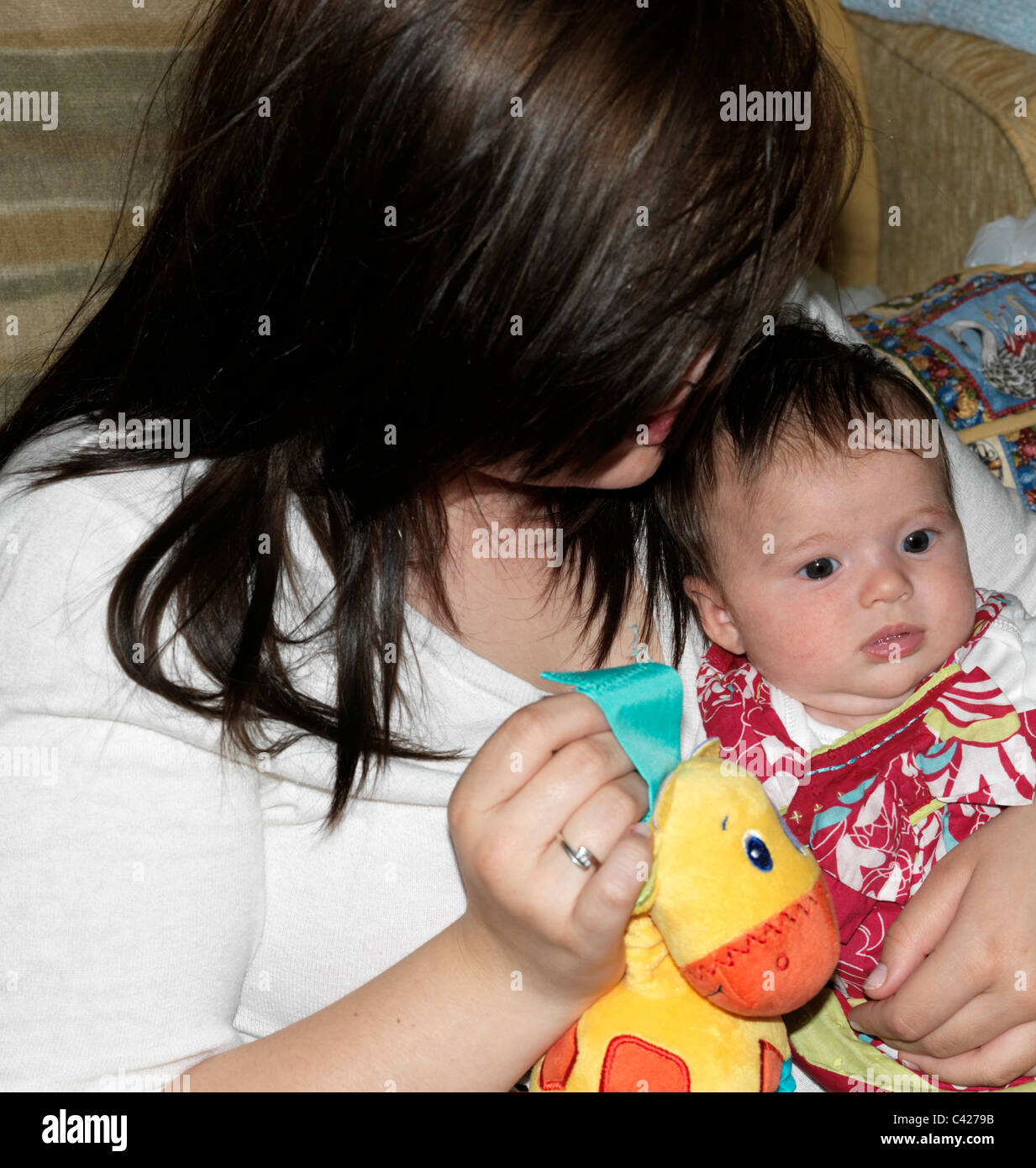 Teenage Girl Holding Baby With Cuddly Toy England Stock Photo Alamy