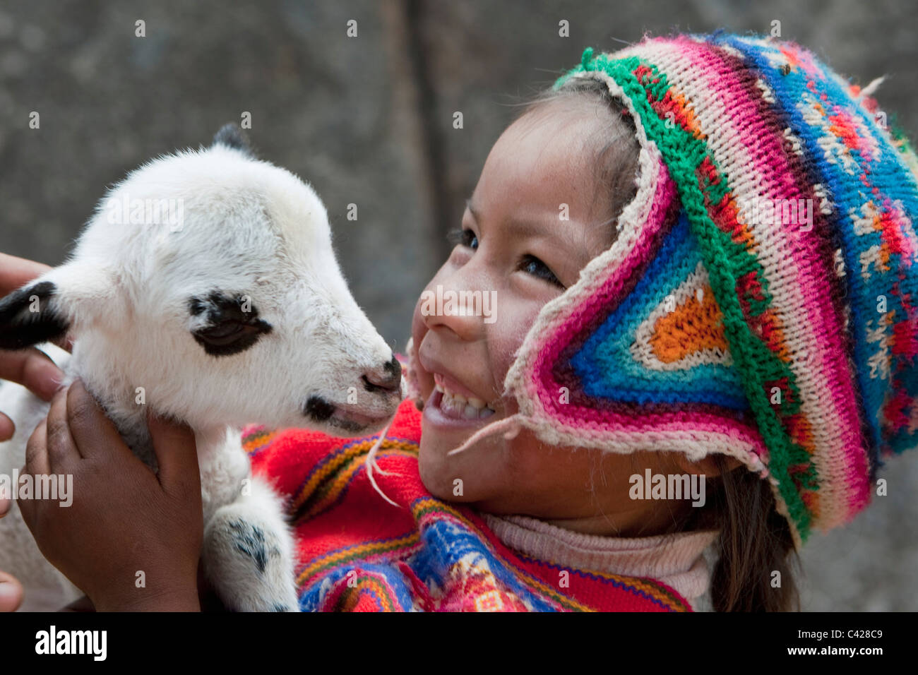 Peru, Cusco, Cuzco, Saqsayhuaman, Sacsayhuaman, Sacsaywaman. Indian girl with lamb. UNESCO World Heritage Site. Stock Photo