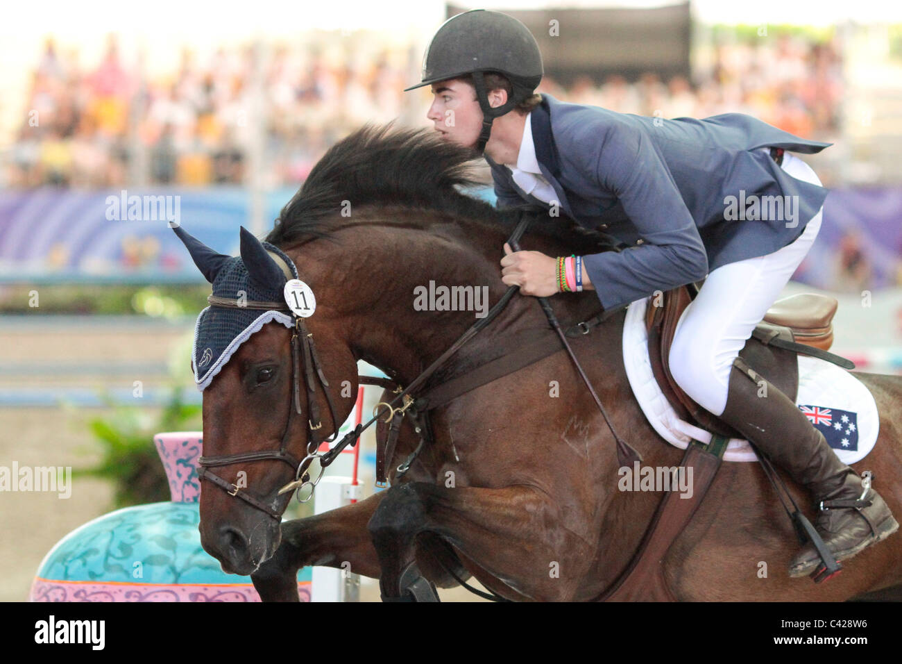 Thomas McDermott of Australia riding HUGO during the 2010 Singapore Youth Olympic Games Equestrian Jumping Individual Round B. Stock Photo