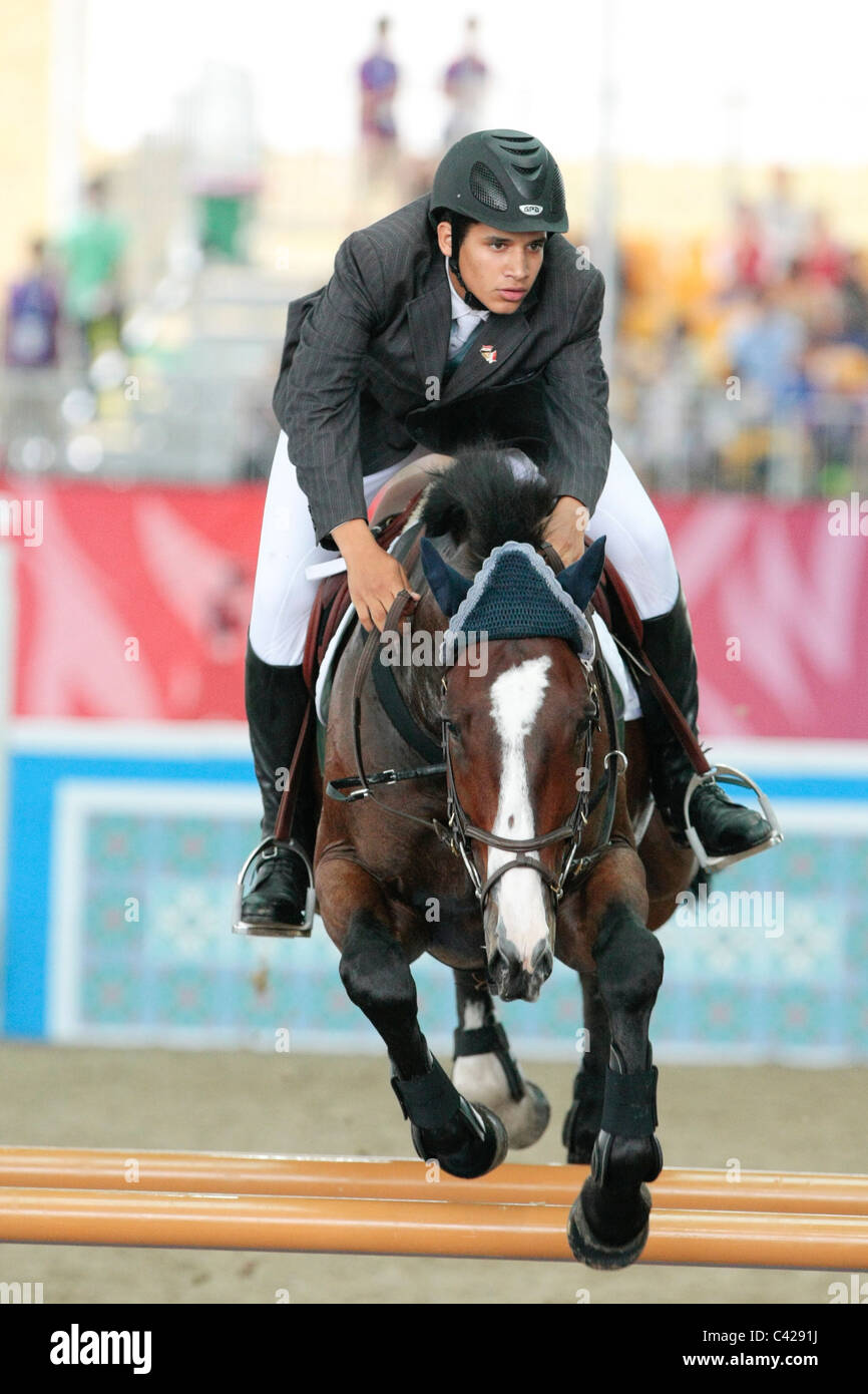 Mohamed Abdalla of Egypt riding BUZZWORD representing Africa in the 2010 Singapore Youth Olympic Games Jumping Team Round 2. Stock Photo