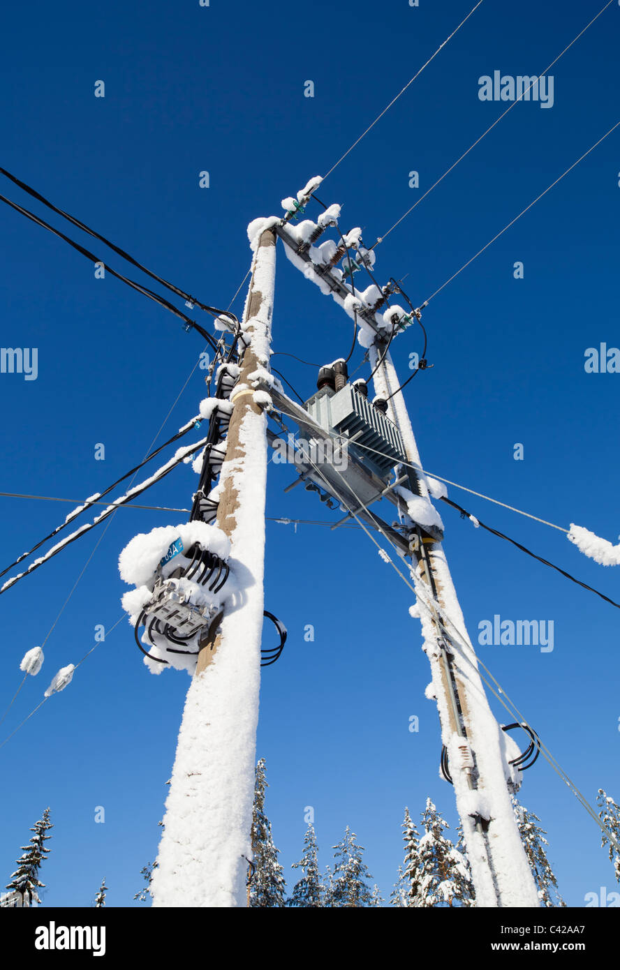 Snow covered step-down transformer from 110 kilovolts to 220-240 Volts , Finland Stock Photo