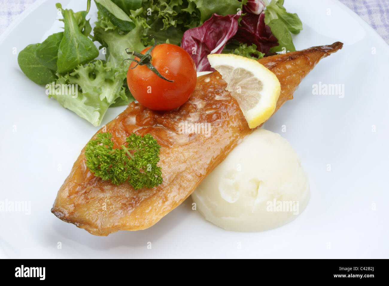 smoked mackerel fillet with tomato on mash potato Stock Photo Alamy