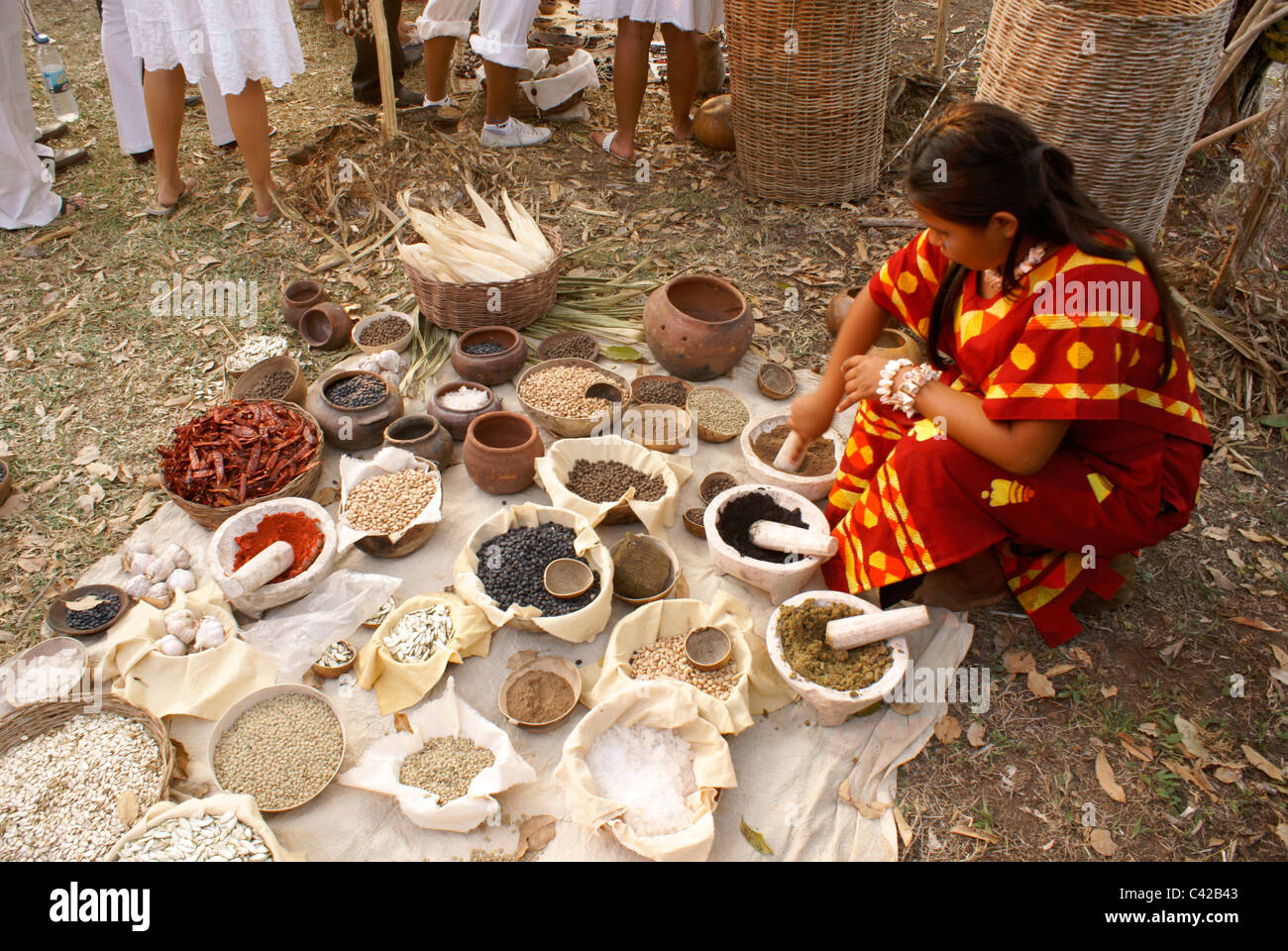 Woman grinding spices and herbs at a Mayan market, Sacred Mayan Journey