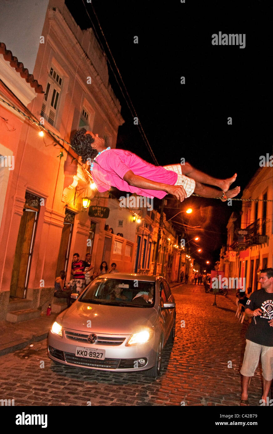 Tight rope entertainer performing in evening Olinda Brazil Stock Photo