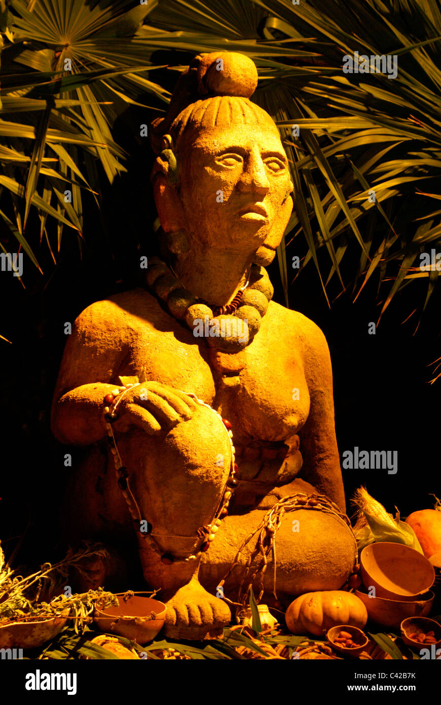 Statue of Ixchel, a Mayan fertility and moon goddess, surrounded by offerings, Xcaret park, Riviera Maya, Quintana Roo, Mexico Stock Photo
