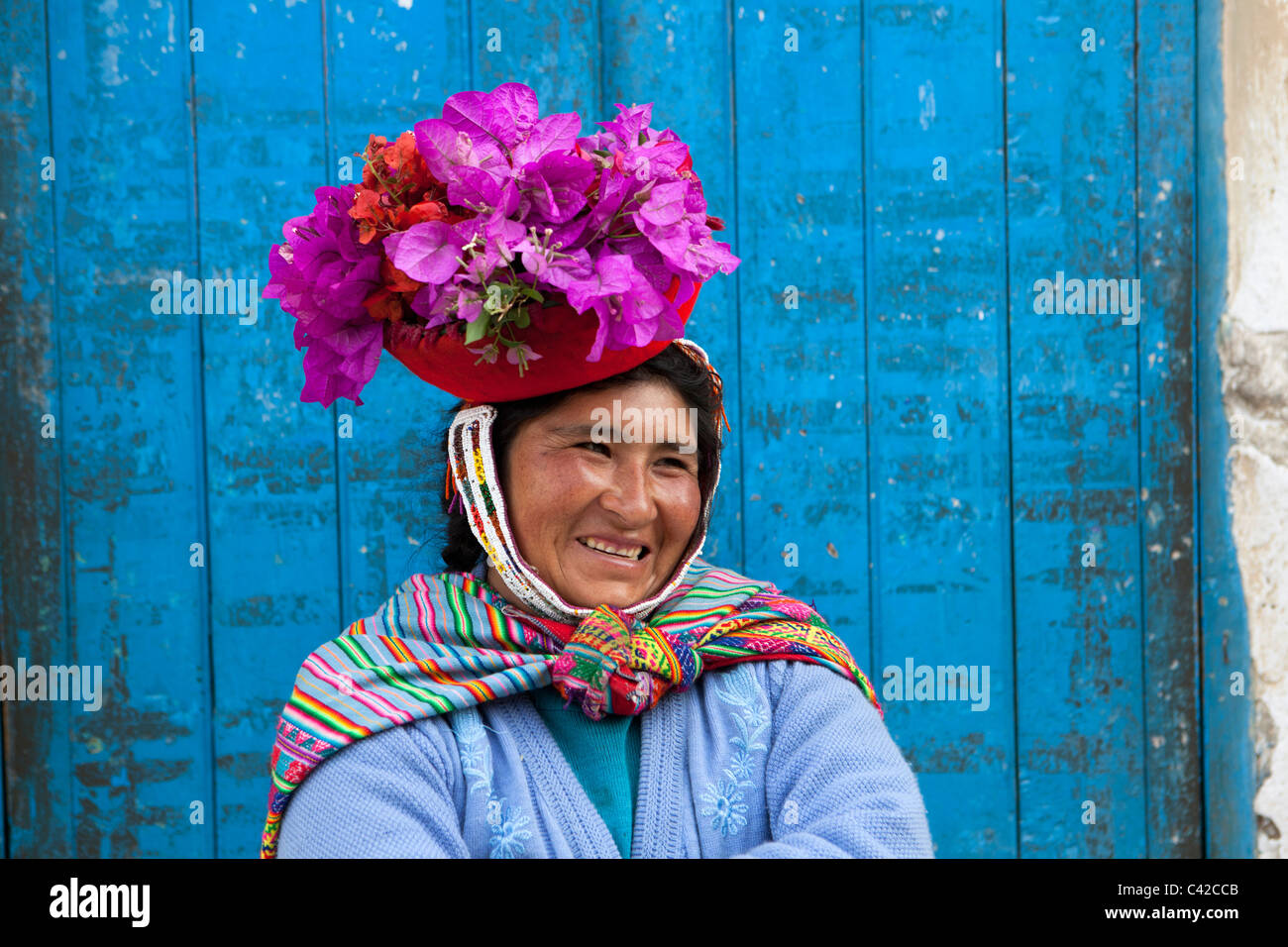 Peru, Ollantaytambo, Indian woman with flowers in hat, an Indian custom. Stock Photo