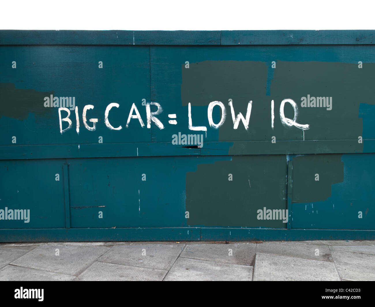 anti-car graffiti on hoardings big car low iq Stock Photo
