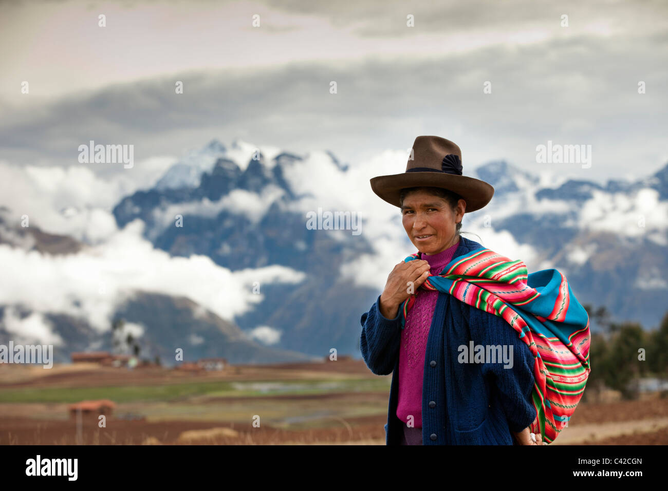 Peru, Chinchero, Farmer's woman, Indian, in front of snowcovered Andes mountains. Stock Photo