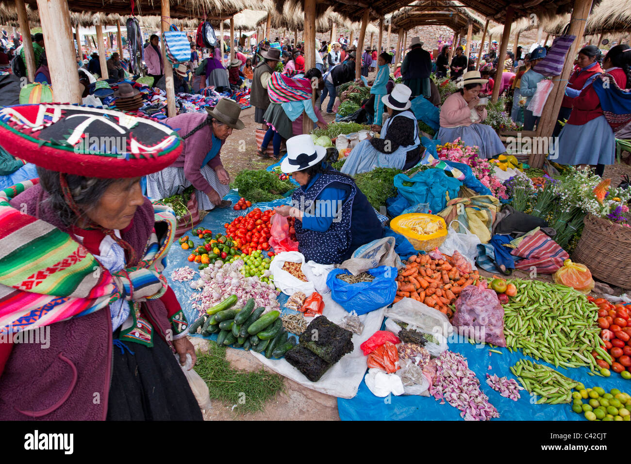 Peru, Chinchero, Women on market selling and buying fruit, flowers and vegetables. Stock Photo