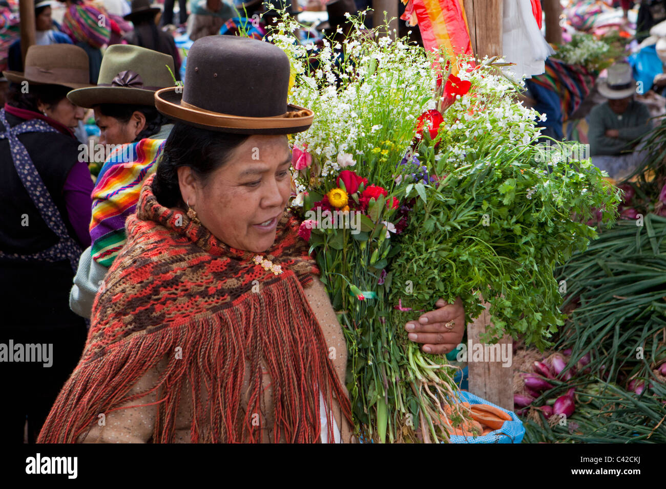 Peru, Chinchero, Woman on market buying flowers. Stock Photo