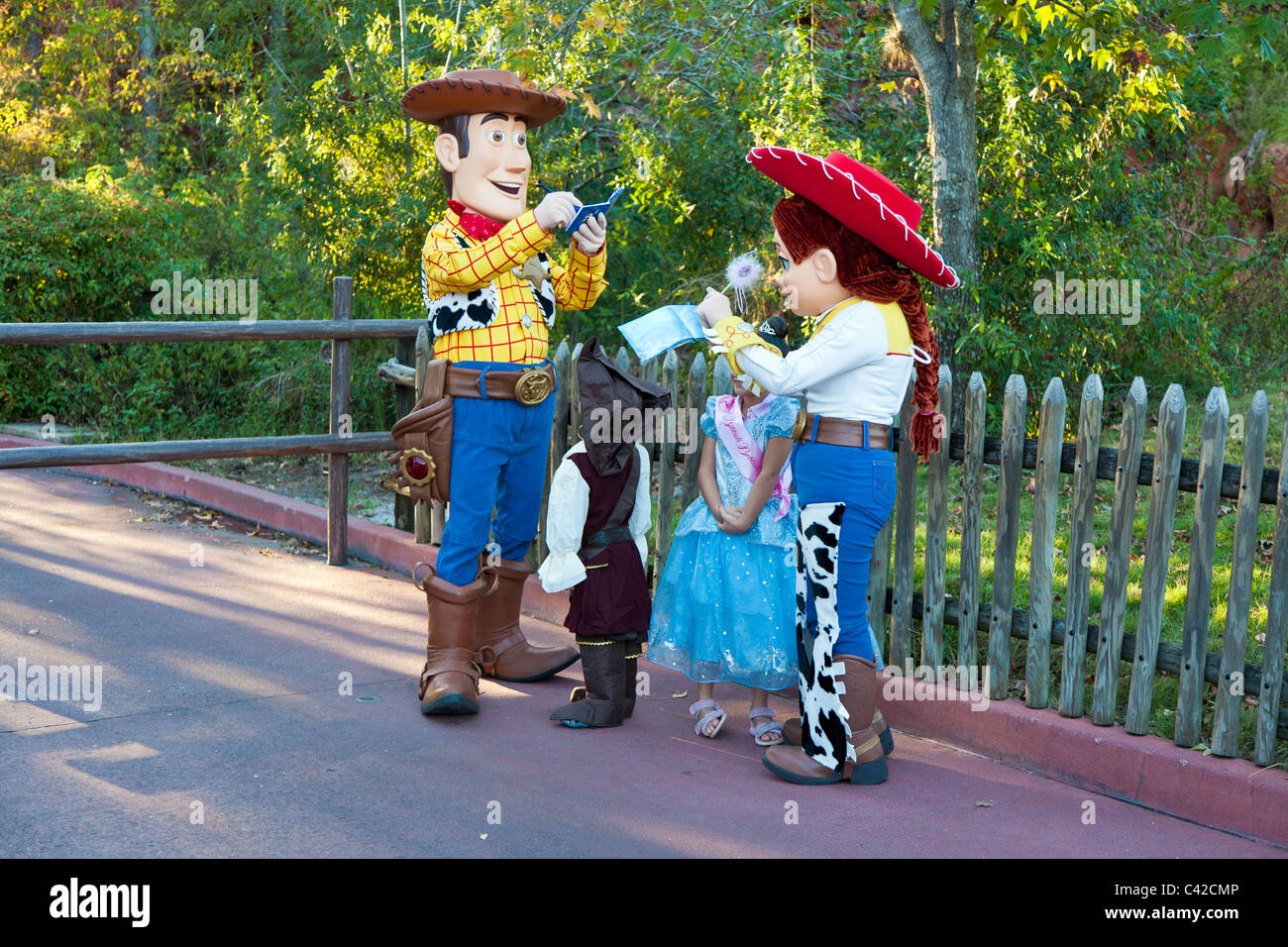 Toy Story characters Woody and Jessie sign autographs for young children in Magic Kingdom at Disney World, Kissimmee, Florida Stock Photo