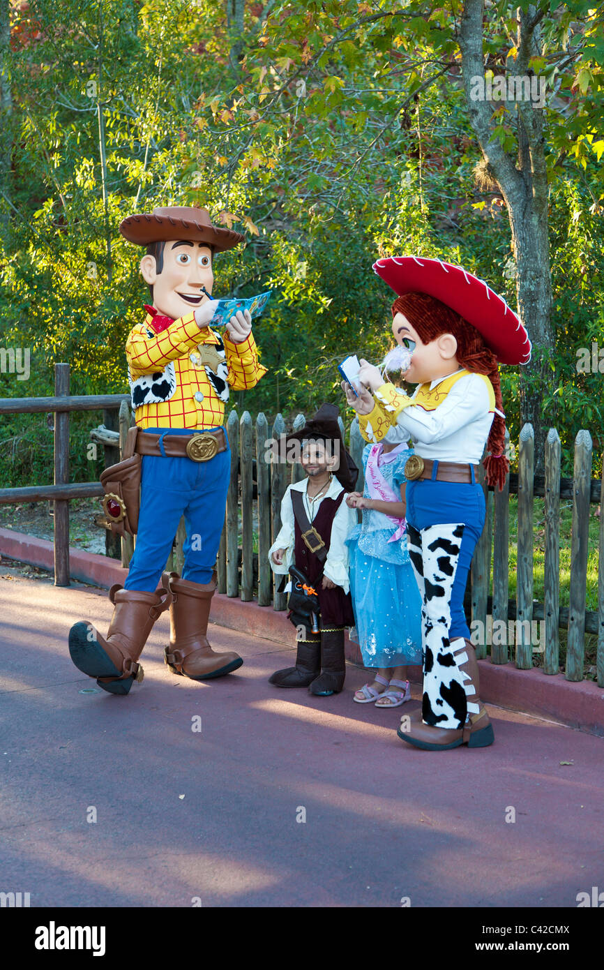 Toy Story characters Woody and Jessie sign autographs for young children in Magic Kingdom at Disney World, Kissimmee, Florida Stock Photo
