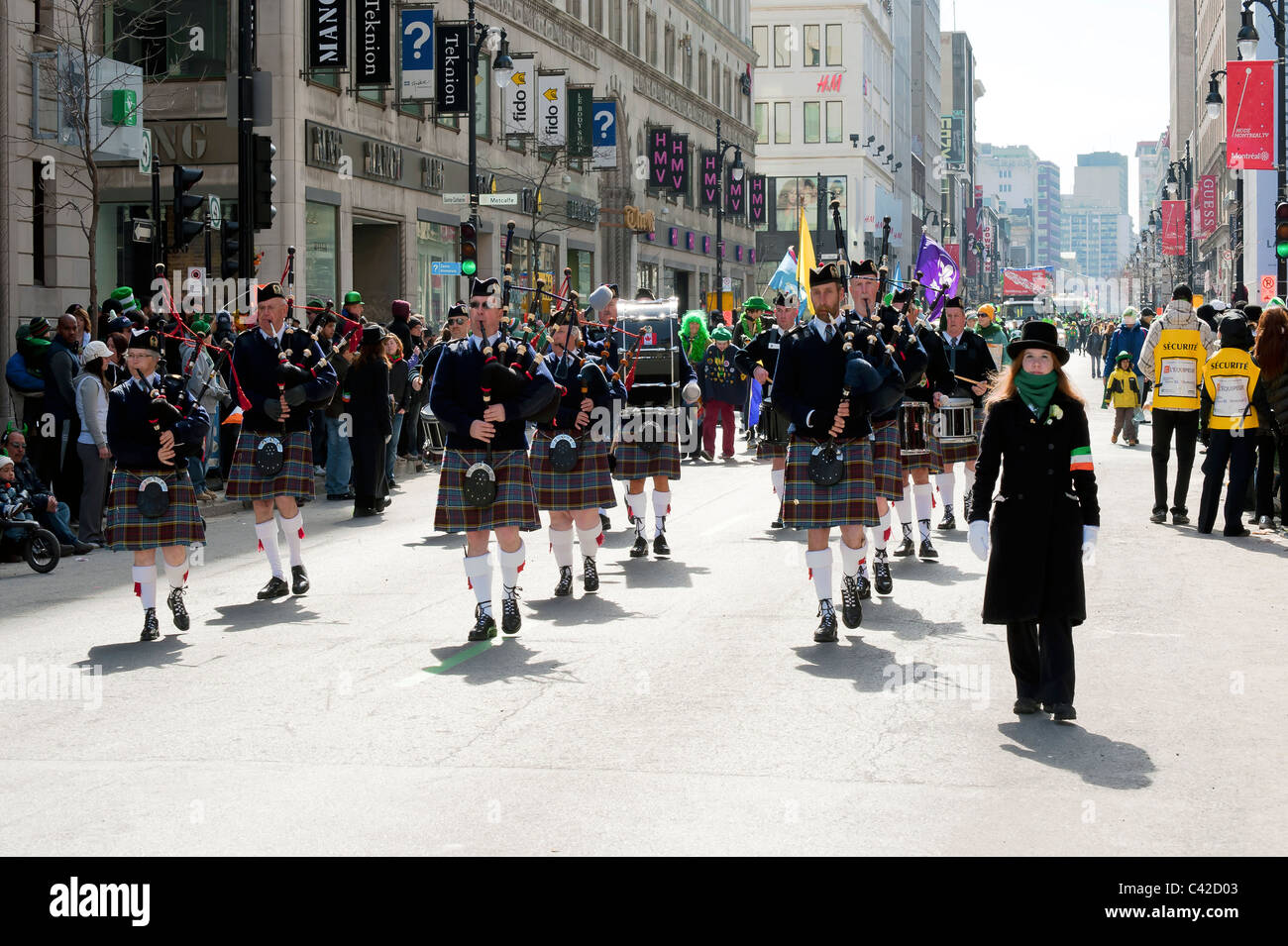 Traditional pipe band marching on Ste Catherine street in Montreal