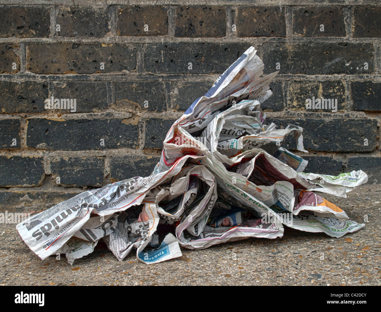 Newspaper on street being blown by the wind Stock Photo Alamy