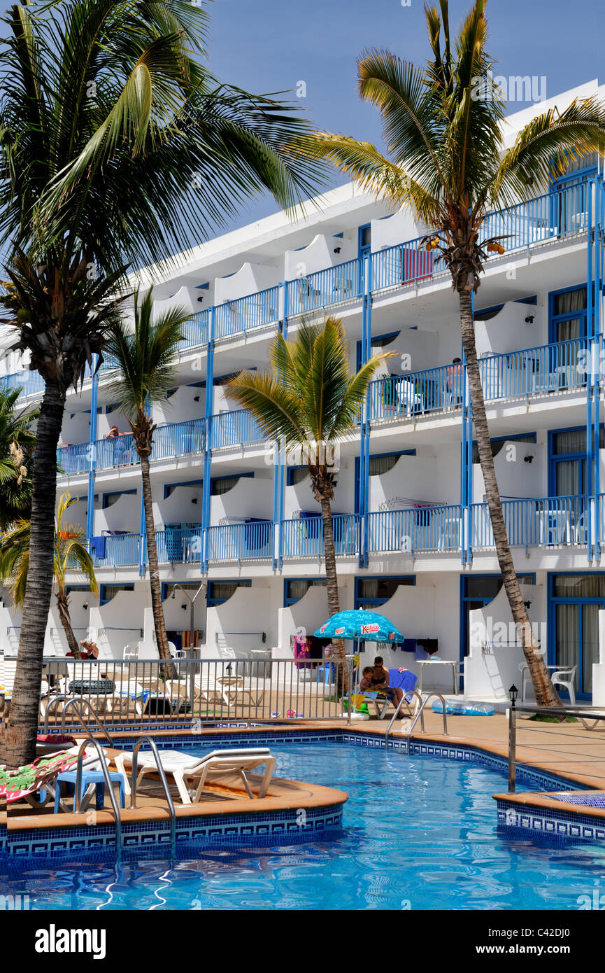 Swimming pool, balconies, palm tree of hotel apartments Puerto del