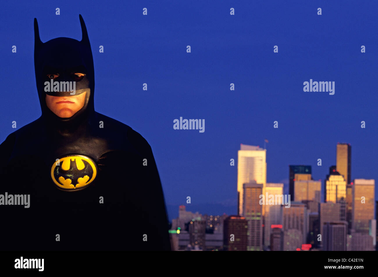 retro image of Man dressed as Batman standing beside Seattle Skyline at  Twilight Stock Photo - Alamy